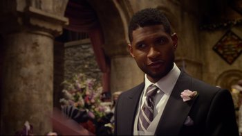 Movie still from “Muppets Most Wanted” (2014), directed by James Bobin – A person wearing a suit and tie; Close Up shot, Over the shoulder angle