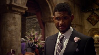 Movie still from “Muppets Most Wanted” (2014), directed by James Bobin – A person wearing a suit and tie; Close Up shot, Over the shoulder angle