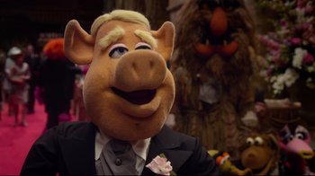Movie still from “Muppets Most Wanted” (2014), directed by James Bobin – A man in a suit and tie with a pig mask on; Close Up shot, Over the shoulder angle