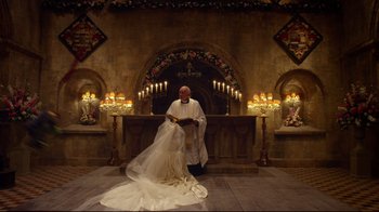 Movie still from “Muppets Most Wanted” (2014), directed by James Bobin – A priest standing in front of a church alter; Wide shot, High angle