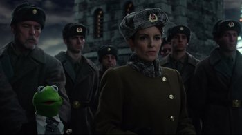 Movie still from “Muppets Most Wanted” (2014), directed by James Bobin – A group of men in military uniforms standing next to each other in front of a stone building; Medium shot, Low angle
