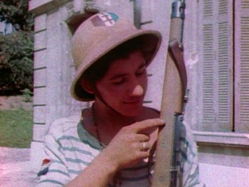Movie still from “Five Came Back” (2017), directed by Laurent Bouzereau – A young man wearing a hat and holding a rifle; Close Up shot, Low angle