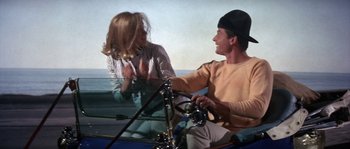 Movie still from “Muscle Beach Party” (1964), directed by William Asher – A man and a woman sitting in a boat on the water; Medium shot, High angle