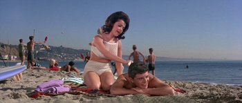 Movie still from “Muscle Beach Party” (1964), directed by William Asher – A man and a woman on the beach; Medium shot, Low angle