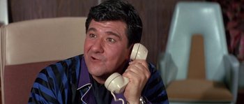 Movie still from “Muscle Beach Party” (1964), directed by William Asher – A person talking on a phone; Close Up shot, Low angle