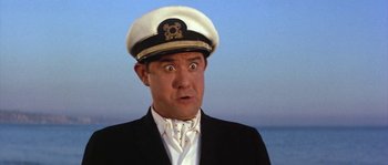 Movie still from “Muscle Beach Party” (1964), directed by William Asher – A person wearing a uniform and a hat; Close Up shot, Low angle