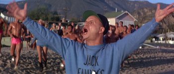 Movie still from “Muscle Beach Party” (1964), directed by William Asher – A man in a baseball cap is yelling at a group of people; Medium shot, Low angle