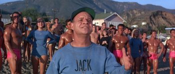 Movie still from “Muscle Beach Party” (1964), directed by William Asher – A group of people standing in front of each other; Medium shot, Low angle