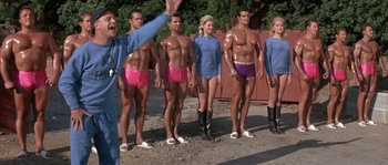 Movie still from “Muscle Beach Party” (1964), directed by William Asher – A group of people standing next to each other wearing underwear; Wide shot, Low angle