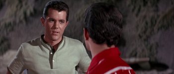 Movie still from “Muscle Beach Party” (1964), directed by William Asher – A man talking to another man in front of a mirror; Close Up shot, Over the shoulder angle