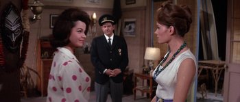 Movie still from “Muscle Beach Party” (1964), directed by William Asher – A group of people standing in a living room; Medium shot, Over the shoulder angle