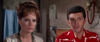 Movie still from “Muscle Beach Party” (1964), directed by William Asher – A woman and a man are standing next to each other; Close Up shot, Over the shoulder angle