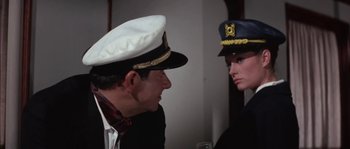Movie still from “Muscle Beach Party” (1964), directed by William Asher – A man and a woman in uniform talking to each other; Medium shot, Over the shoulder angle