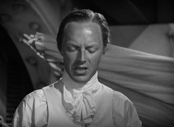Movie still from “Mutiny on the Bounty” (1935), directed by Frank Lloyd – A man in a white dress shirt and tie; Close Up shot, Low angle