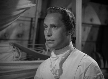 Movie still from “Mutiny on the Bounty” (1935), directed by Frank Lloyd – A black and white photo of a man in a white shirt; Close Up shot, Low angle