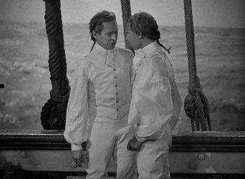 Movie still from “Mutiny on the Bounty” (1935), directed by Frank Lloyd – Two men standing next to each other on a boat; Medium shot, High angle