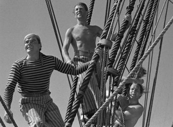 Movie still from “Mutiny on the Bounty” (1935), directed by Frank Lloyd – A group of men standing on top of a boat; Medium shot, Low angle