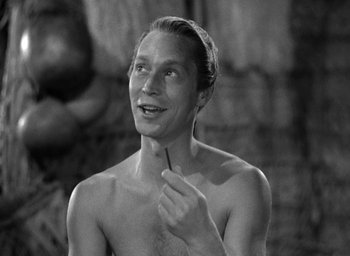 Movie still from “Mutiny on the Bounty” (1935), directed by Frank Lloyd – A shirtless man pointing to his chest in a black and white photo; Close Up shot, Over the shoulder angle