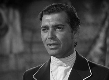 Movie still from “Mutiny on the Bounty” (1935), directed by Frank Lloyd – Black and white photograph of a man wearing a suit; Close Up shot, Low angle