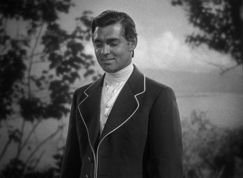 Movie still from “Mutiny on the Bounty” (1935), directed by Frank Lloyd – A black and white photo of a man in a suit; Medium shot, High angle