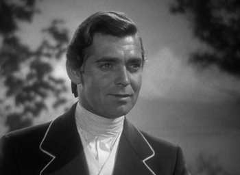 Movie still from “Mutiny on the Bounty” (1935), directed by Frank Lloyd – Black and white photograph of a man in a suit; Close Up shot, Low angle