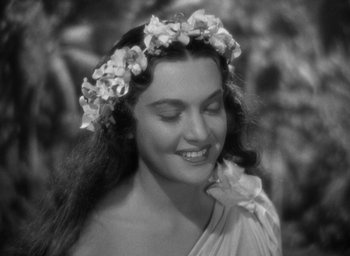 Movie still from “Mutiny on the Bounty” (1935), directed by Frank Lloyd – A black - and - white photo of a woman wearing a wreath of flowers; Close Up shot, High angle