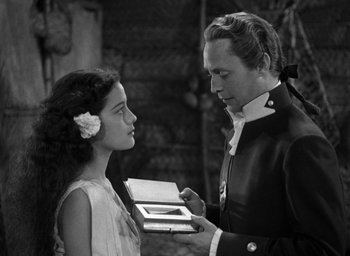 Movie still from “Mutiny on the Bounty” (1935), directed by Frank Lloyd – A man and a girl are looking at each other; Medium shot, Over the shoulder angle