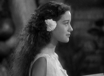 Movie still from “Mutiny on the Bounty” (1935), directed by Frank Lloyd – A young girl with a flower in her hair; Close Up shot, Over the shoulder angle