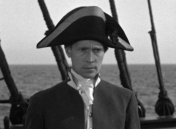 Movie still from “Mutiny on the Bounty” (1935), directed by Frank Lloyd – A man wearing a pirate's hat on a boat; Medium shot, High angle