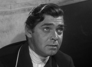 Movie still from “Mutiny on the Bounty” (1935), directed by Frank Lloyd – A man that is wearing a suit; Close Up shot, Over the shoulder angle