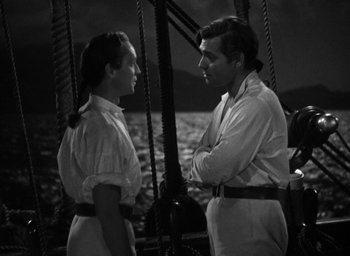 Movie still from “Mutiny on the Bounty” (1935), directed by Frank Lloyd – A man and a woman standing next to each other on a boat; Medium shot, High angle