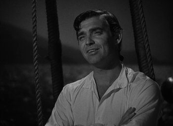 Movie still from “Mutiny on the Bounty” (1935), directed by Frank Lloyd – Black and white photograph of a man smiling; Close Up shot, Low angle