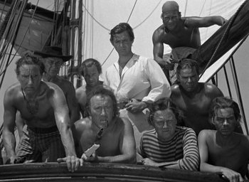 Movie still from “Mutiny on the Bounty” (1935), directed by Frank Lloyd – A black and white photo of a group of people on a boat; Medium shot, Low angle