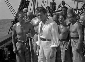 Movie still from “Mutiny on the Bounty” (1935), directed by Frank Lloyd – A group of men standing next to each other on a boat; Medium shot, High angle