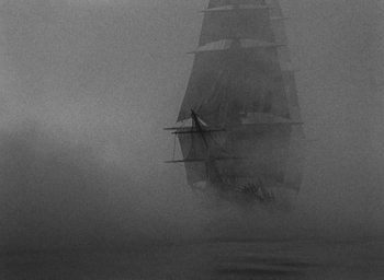 Movie still from “Mutiny on the Bounty” (1935), directed by Frank Lloyd – A black and white photo of a boat in the fog; Extreme Wide shot, Low angle