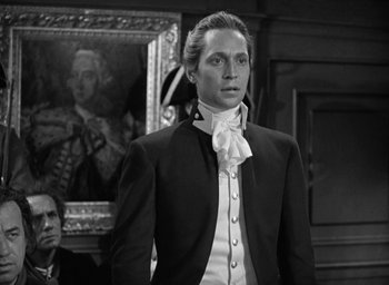 Movie still from “Mutiny on the Bounty” (1935), directed by Frank Lloyd – A man in a suit standing in front of a painting; Medium shot, Over the shoulder angle