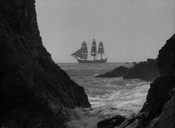 Movie still from “Mutiny on the Bounty” (1935), directed by Frank Lloyd – A black and white photo of a boat in the ocean; Extreme Wide shot, Low angle