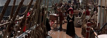Movie still from “Mutiny on the Bounty” (1962), directed by George Seaton – A group of people standing on top of a boat; Wide shot, High angle