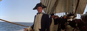 Movie still from “Mutiny on the Bounty” (1962), directed by George Seaton – A man in a uniform on a boat; Medium shot, Low angle