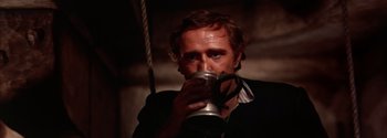 Movie still from “Mutiny on the Bounty” (1962), directed by George Seaton – A man drinking from a metal mug; Close Up shot, Low angle