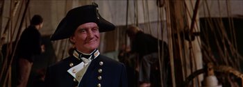 Movie still from “Mutiny on the Bounty” (1962), directed by George Seaton – A person wearing a uniform; Medium shot, Low angle