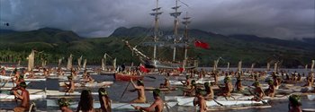 Movie still from “Mutiny on the Bounty” (1962), directed by George Seaton – A group of people in canoes on a body of water; Extreme Wide shot, High angle