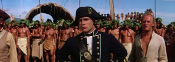 Movie still from “Mutiny on the Bounty” (1962), directed by George Seaton – A person wearing a hat; Medium shot, Low angle