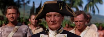 Movie still from “Mutiny on the Bounty” (1962), directed by George Seaton – A person wearing a uniform and a hat; Close Up shot, High angle