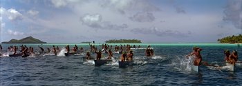 Movie still from “Mutiny on the Bounty” (1962), directed by George Seaton – A group of people rowing boats in the ocean; Extreme Wide shot, High angle