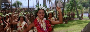 Movie still from “Mutiny on the Bounty” (1962), directed by George Seaton – A group of young women in floral garb dancing; Medium shot, High angle