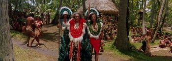 Movie still from “Mutiny on the Bounty” (1962), directed by George Seaton – A group of people in costumes walking down a street; Medium shot, High angle