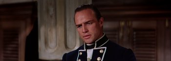 Movie still from “Mutiny on the Bounty” (1962), directed by George Seaton – A person wearing a uniform; Close Up shot, Low angle