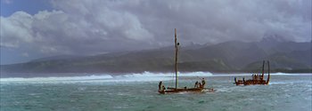 Movie still from “Mutiny on the Bounty” (1962), directed by George Seaton – A small boat in the ocean with people on it; Extreme Wide shot, High angle