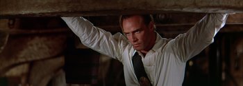 Movie still from “Mutiny on the Bounty” (1962), directed by George Seaton – A man in a white shirt and a black tie; Close Up shot, Low angle